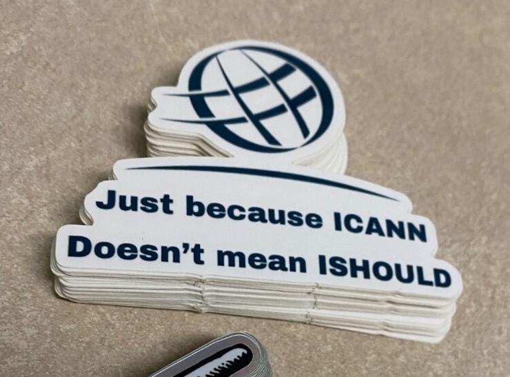 a pile of stickers with the text "Just because ICANN doesn't mean ISHOULD"